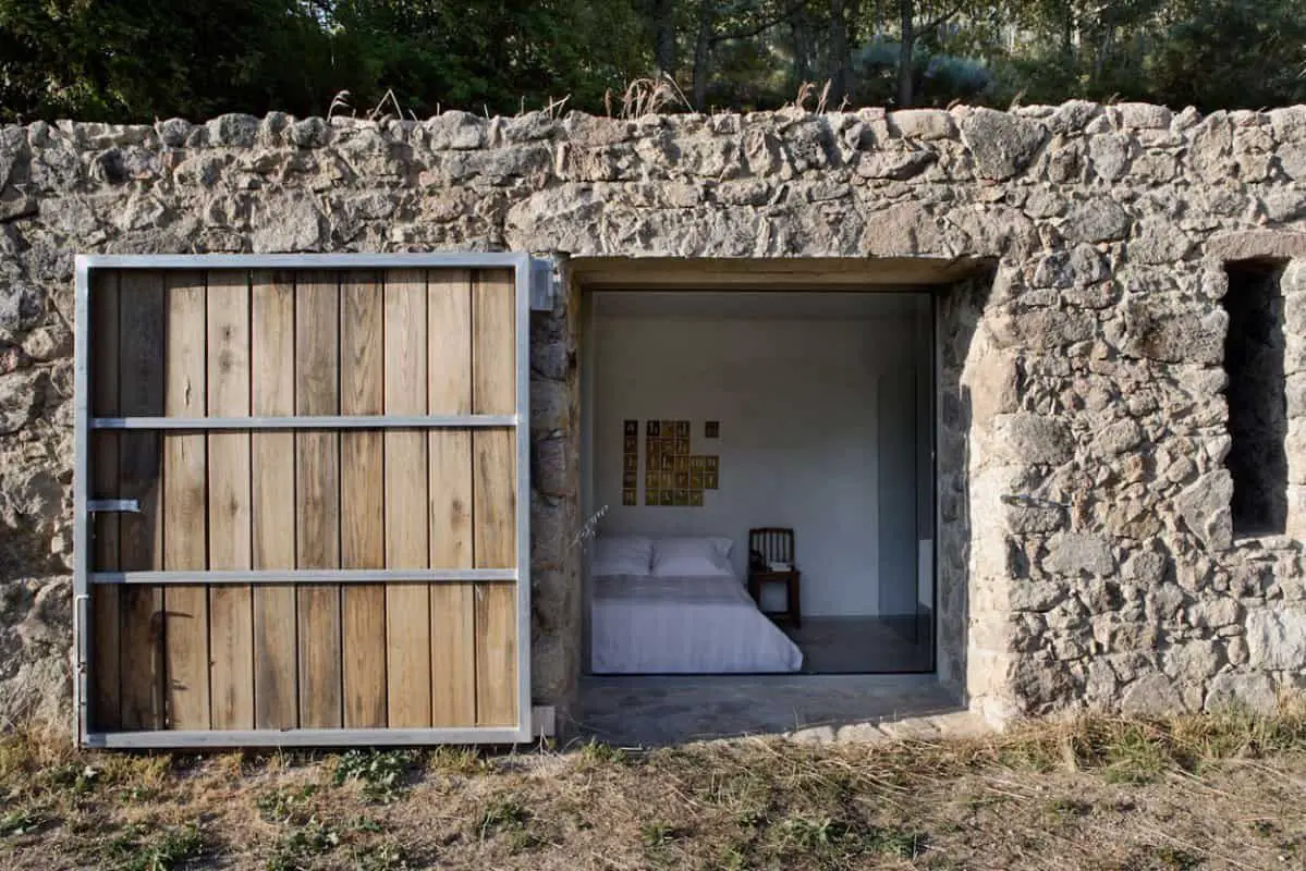 Fabulous-Bedroom-View-in-Finca-en-Extremadura-with-Wide-Bed-White-Quilt-White-Cushions-and-Concrete-Floor