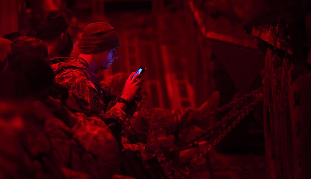 A_U.S._Soldier_assigned_to_Apache_Troop_1st_Squadron_2nd_Cavalry_Regiment_checks_his_phone_prior_to_offloading_from_an_Air_Force_C-17_Globemaster_III_aircraft_in_Latvia_Sept_140905-F-IM476-006