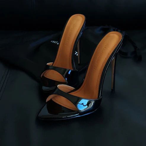 2. Cult of Coquette Black Patent Mules Are you ready to slay? Cult of Coquette makes shoes for true femmes fatales. Their best-selling black patent mule has become an instant classic, taking you from season to season and year to year. We love how there's a bit of padding inside the shoe, making them all that bit more comfortable to walk in. The style: A sexy, open toed vegan sandal  Price: Around $215